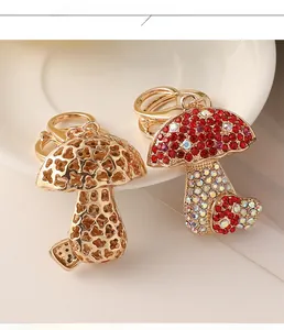 Detail of cute mushroom keychains featuring red crystal pavé and golden hollow metal design