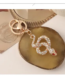 Close-up of sparkling snake keychain with crystal rhinestones on brown agate base