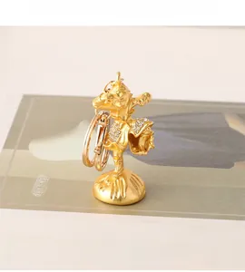 Detailed close-up of golden Sun Wukong keychain with sparkling crystal embellishments