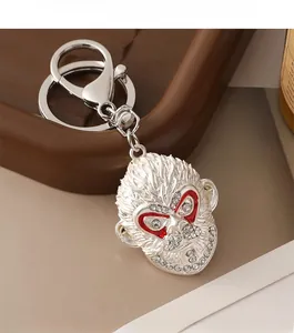 Detailed close-up of a silver Monkey King keychain featuring sparkling rhinestones and red eyes