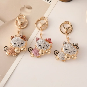Sparkling rhinestone kitten keychains in gold finish for women's bags and keys