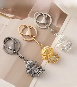 Detailed macro view of Monkey King keychains encrusted with rhinestones in gold and silver