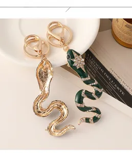 Detail of snake keychain with green enamel, crystals and gold lobster clasp