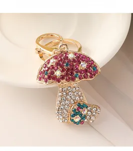 Close-up of double mushroom keychain with vibrant crystals and gold lobster clasp