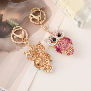 Sparkling crystal owl keychain in pink and purple with a golden hollow back and ring