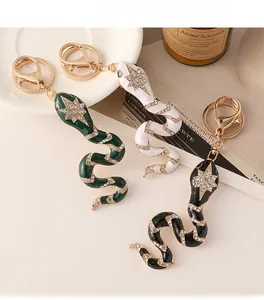 Detail of snake keychains in green, white, and black with sparkling star rhinestones