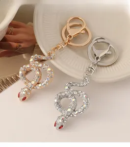 Detailed close-up of diamond-encrusted snake keychains in gold and silver finishes
