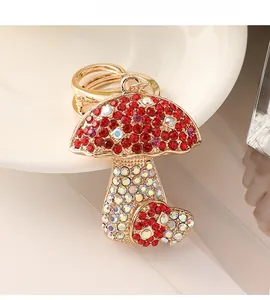 Close-up of cute mushroom keychain featuring red crystals and sparkling colorful rhinestones
