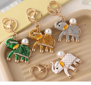 Detail showing vintage elephant keychains with colorful rhinestones and pearls