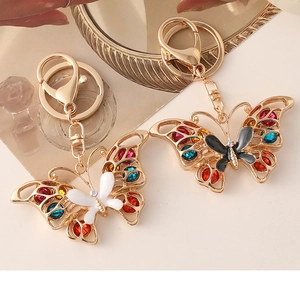 Close-up of butterfly keychains with colorful rhinestones and polished gold plating