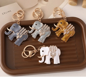 Detailed set of four rhinestone-encrusted elephant keychains in assorted colors