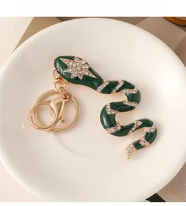 Detailed close-up of green enamel snake keychain with sparkling diamond accents