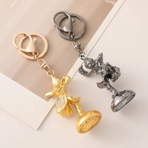 Chinese Zodiac Monkey King keychain in gold and silver metal with sparkling rhinestones