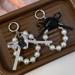 Elegant PU rose keychain with pearl strands and bow tie charm for bags and car keys