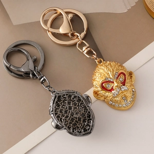 Golden and black Sun Wukong monkey keychains with sparkling rhinestones and enamel eyes