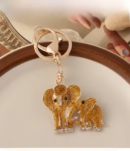 Detailed macro view of a golden elephant keychain with sparkling glitter and crystal accents