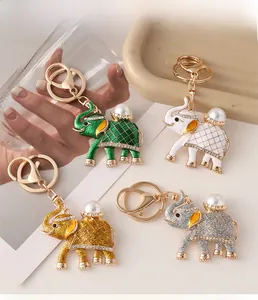 Detail showing four colored elephant keychains with pearls and rhinestones