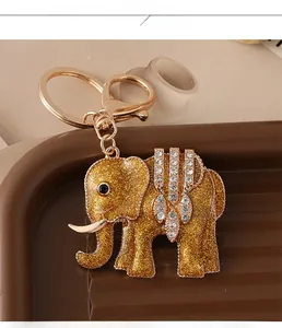 Detail of a golden elephant keychain with sparkling glitter and rhinestone inlay accents