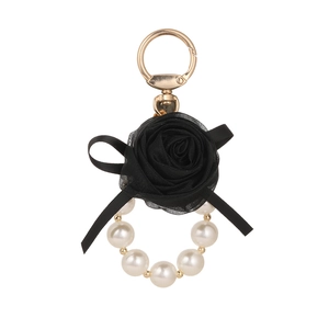 Elegant black mesh rose keychain with white pearls and silk bow on gold metal clasp