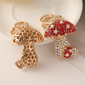 Creative crystal mushroom keychain with red rhinestones and gold hollow metal design