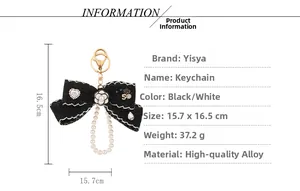 Detail view of lace bow keychain with camellia, pearl chain and alloy charms specifications
