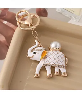 Detailed view of vintage elephant keychain with white pearls and sparkling crystals