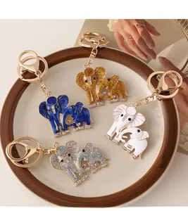 Detail of colorful enamel elephant keychains with rhinestones in a luxury ceramic tray