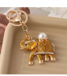 Detailed macro of golden elephant keychain with sparkling glitter and crystal rhinestone inlay