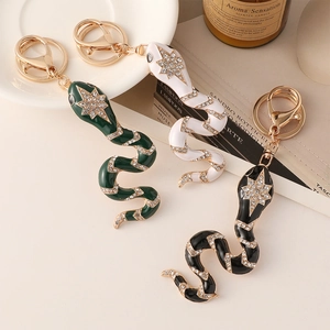 Creative snake keychain with enamel and crystals in black, white and green colors