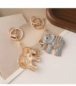 Detailed view of rhinestone elephant keychain with silver glitter and gold metal backing