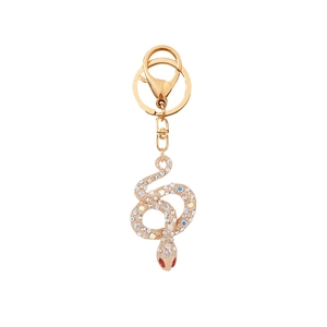 Elegant gold snake keychain with sparkling white crystals and red gem eyes for bags