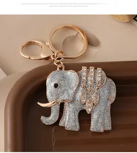 Detail of silver glitter elephant keychain with crystal rhinestones and golden lobster clasp
