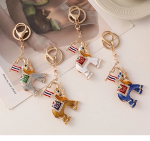 Detailed view of colorful Thai style elephant keychains with crystals and mini flags