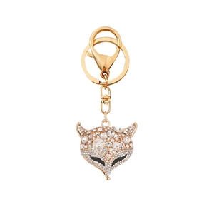 Portachiavi a forma di testa di volpe con strass e metallo dorato su sfondo bianco