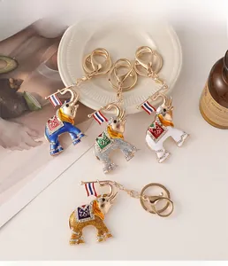 Detailed macro view of four colorful enamel elephant keychains with shiny white rhinestones