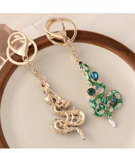 Vue détaillée du porte-clés serpent avec émail vert, cristaux bleus et fermoir mousqueton