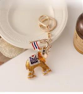 Detailed view of a golden elephant keychain with purple enamel and sparkling crystals