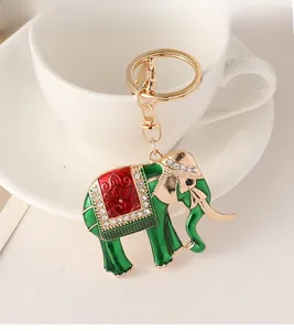 Detailed view of gold alloy elephant keychain with green enamel and white rhinestones