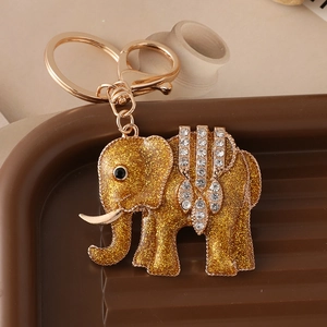 Luxury gold elephant keychain with sparkling rhinestones and glitter finish on brown base