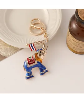 Exquisite gold elephant keychain with blue enamel inlay and sparkling rhinestones