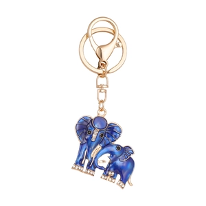 Golden elephant keychain with gradient blue enamel and rhinestones on white background