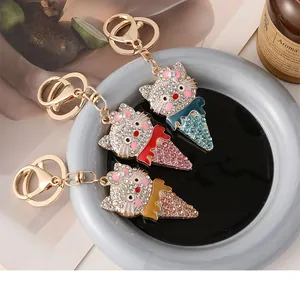 Detailed close-up of cartoon cat ice cream keychains with colorful rhinestones in a tray