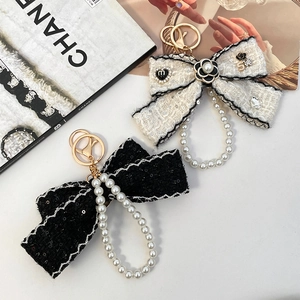 Elegant tweed bow keychain with camellia flower and pearl charm accessories