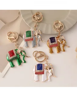 Detail of four colorful elephant keychains with rhinestones and enamel finishes