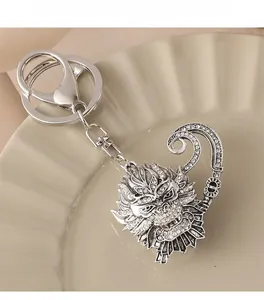 Detailed view of silver Sun Wukong keychain with rhinestones and golden hoop stick detail