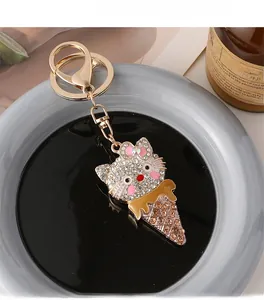 Close-up of diamond-studded ice cream cat keychain with gold-plated alloy and rhinestones