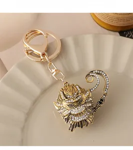 Macro shot of gold Monkey King keychain with sparkling rhinestones on a ceramic plate