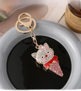 Detailed view of crystal-studded cat ice cream keychain with lobster clasp and ring