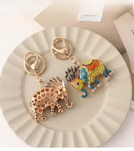 Detailed view of rhinestone elephant keychains in rose gold and colorful enamel finish