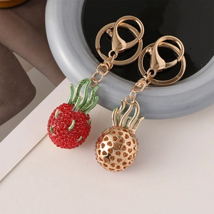 Sparkling crystal dragon fruit and hollow pineapple gold keychain charms for handbags